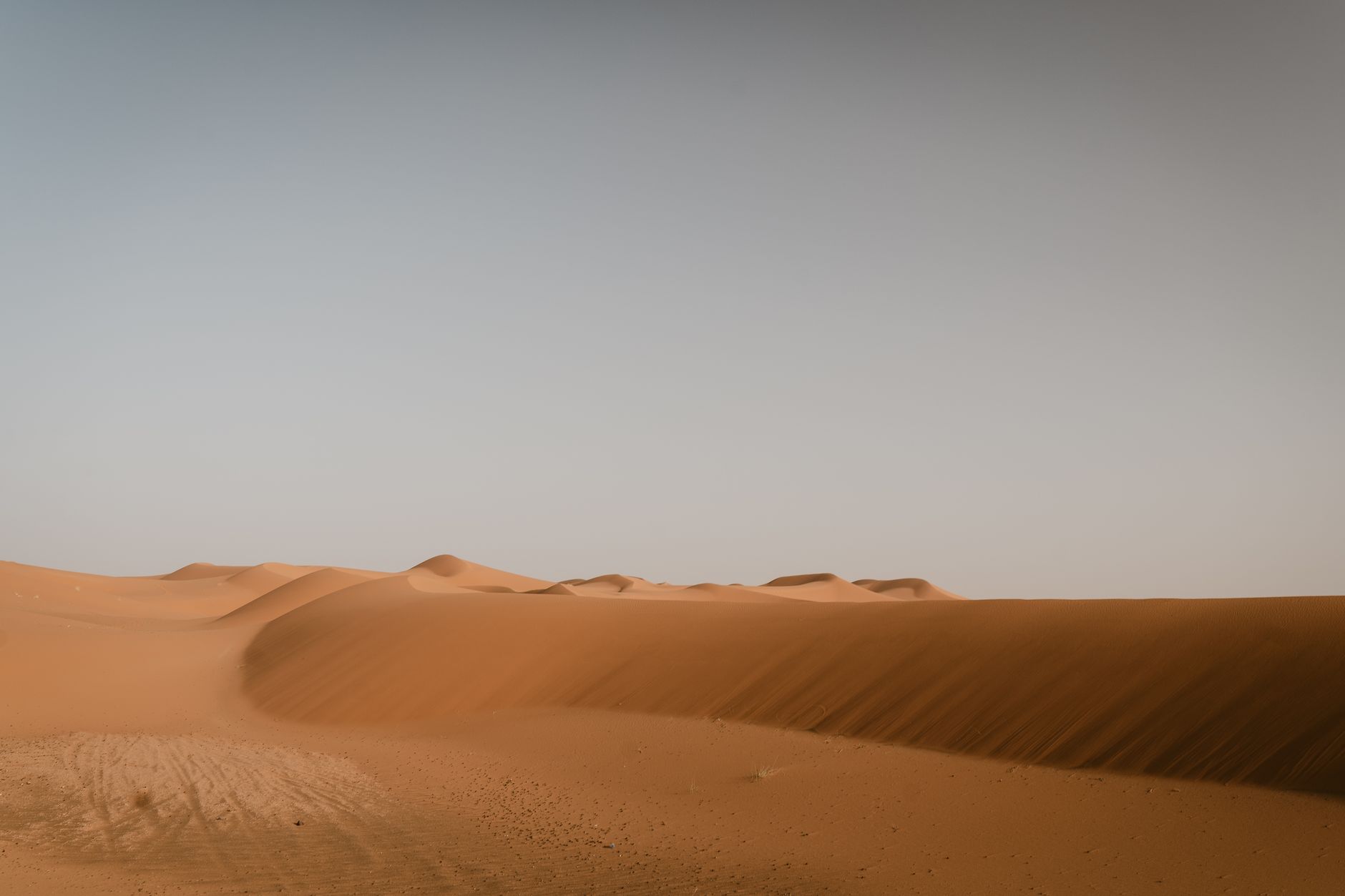 Golden sand dunes glowing at sunset during a tailored Sahara camp experience