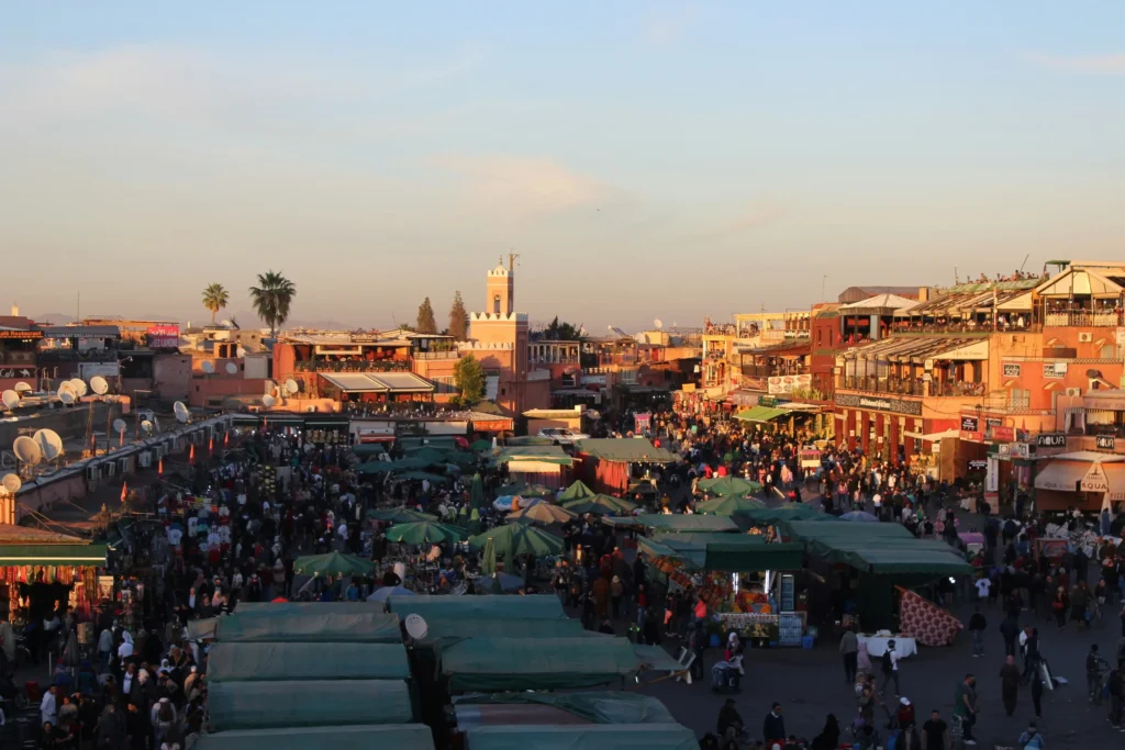 Colorful handmade carpets and Berber crafts displayed in a lively Moroccan market