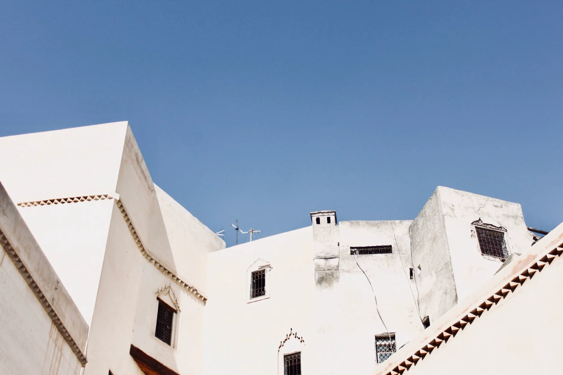 Busy alley of a Moroccan medina with lanterns